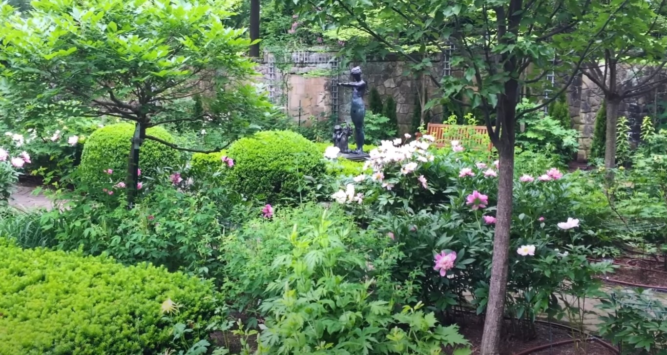 Elegant formal garden with manicured hedges and flowering plants in El Centro, CA